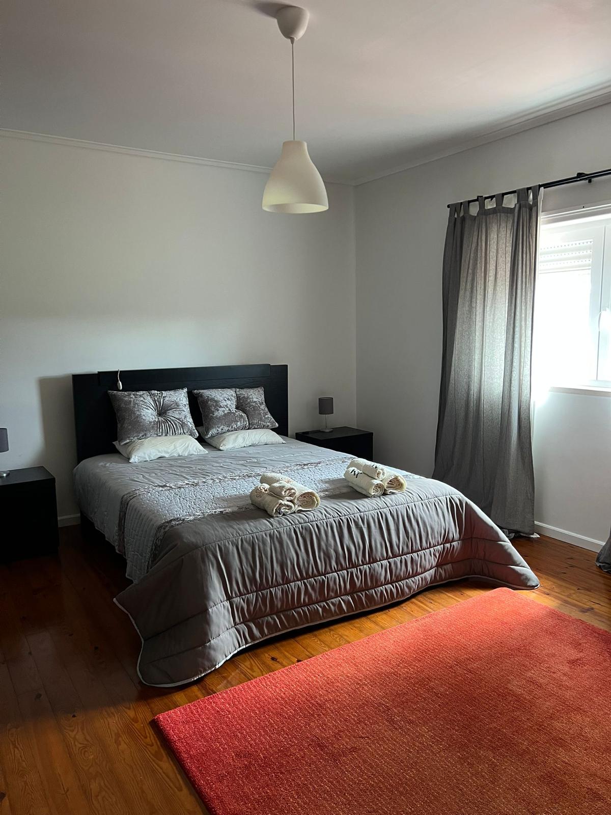 Double bedroom in grey tones — first floor reserved for guests
