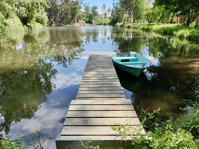Boat moored at a pier on the Barrinha de Mira lagoon