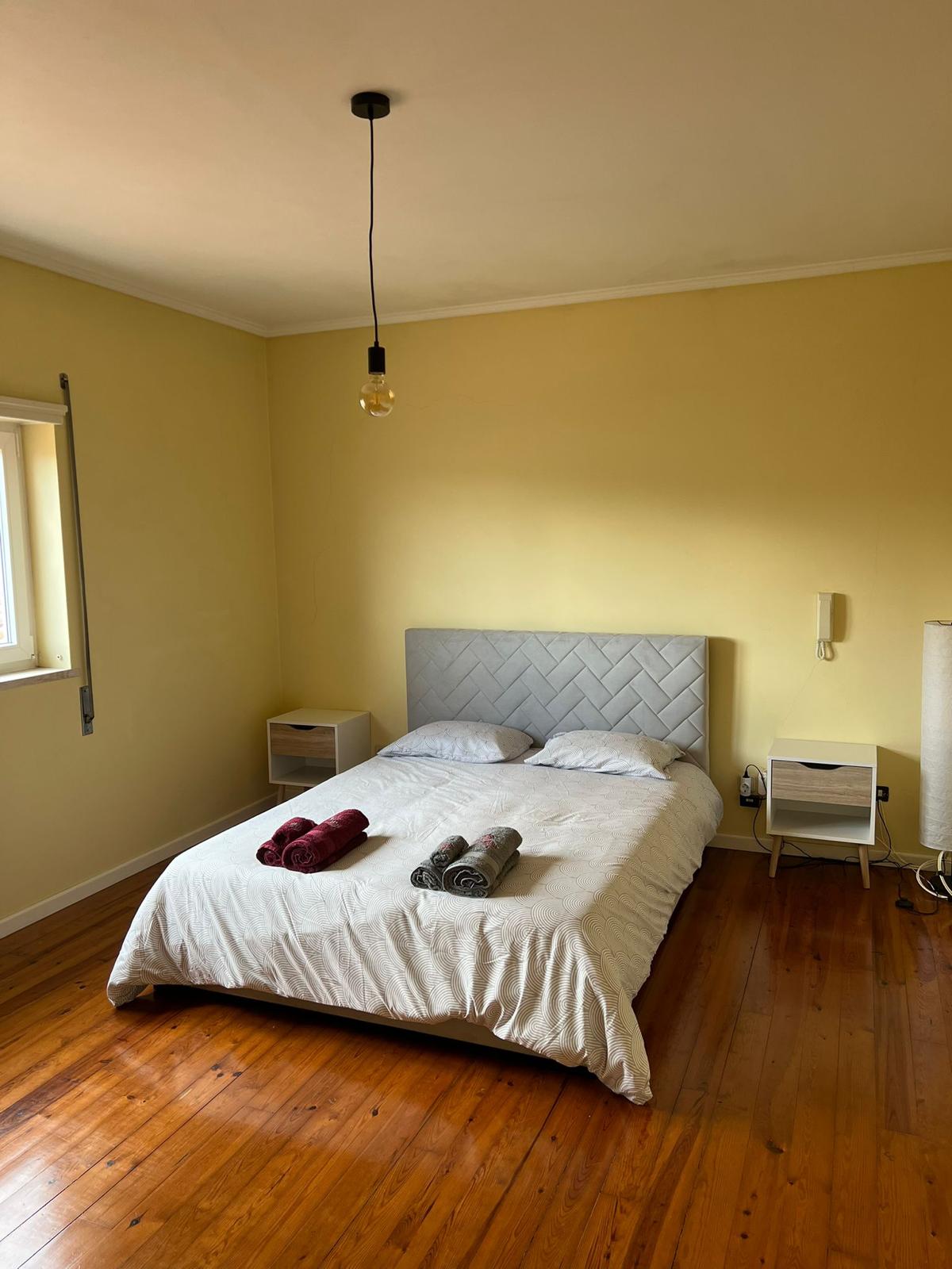 Double bedroom with yellow walls — first floor reserved for guests